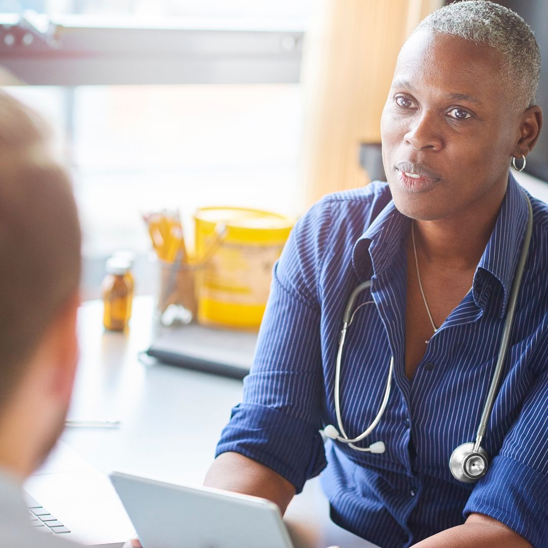 GP talking with a patient during a diabetes check-up, representing awareness and prevention.
